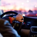 man driving a car wearing wrist watch